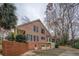 A two-story brick home with two garage doors and a screened-in porch at 1216 Valley Dr, Conyers, GA 30012