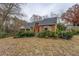 Back of a brick home featuring manicured landscaping and an inviting screened porch at 1216 Valley Dr, Conyers, GA 30012