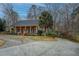 Beautiful brick home featuring a covered porch and lush landscaping at 1216 Valley Dr, Conyers, GA 30012