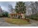 Brick home with a spacious front yard, covered porch, and mature landscaping at 1216 Valley Dr, Conyers, GA 30012