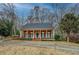 Charming brick home with covered front porch, well-manicured lawn, and established trees at 1216 Valley Dr, Conyers, GA 30012