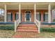 Inviting front porch with brick steps, white columns, and classic architectural details at 1216 Valley Dr, Conyers, GA 30012