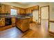 Classic kitchen with wood cabinets, an island cooktop, and a view into the next room at 1216 Valley Dr, Conyers, GA 30012
