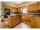 Traditional kitchen featuring wooden cabinetry, granite countertops, a kitchen island, and hardwood floors at 1216 Valley Dr, Conyers, GA 30012