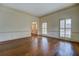 Sunlit living room featuring hardwood floors and access to a grand foyer at 1216 Valley Dr, Conyers, GA 30012