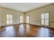 Bright living room with hardwood floors and natural light streaming through shuttered windows at 1216 Valley Dr, Conyers, GA 30012