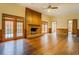 Spacious living room featuring a fireplace, hardwood floors, and natural light from French doors at 1216 Valley Dr, Conyers, GA 30012