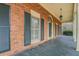 Covered side porch showcasing brick facade and traditional design elements at 1216 Valley Dr, Conyers, GA 30012