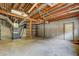 An unfinished basement with exposed ductwork and bare walls with a door to the exterior at 1216 Valley Dr, Conyers, GA 30012