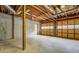 A unfinished garage space with unfinished walls and ceiling, and garage doors with many window panes at 1216 Valley Dr, Conyers, GA 30012