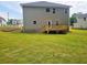 Expansive backyard with lush lawn, wooden deck, and newly laid sod, perfect for outdoor enjoyment at 305 Melanie Ct, Bowdon, GA 30108