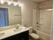 Bright bathroom featuring a double sink vanity, illuminated mirror, and a shower-tub combo with white tile surround at 305 Melanie Ct, Bowdon, GA 30108