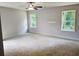 Spacious bedroom with natural light, ceiling fan, and neutral walls, ready for personalization at 305 Melanie Ct, Bowdon, GA 30108