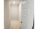Walk-in closet with white wire shelving, neutral walls and trim, and a door that is partially open at 305 Melanie Ct, Bowdon, GA 30108