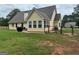 Spacious backyard featuring lush green grass, a fence, and mature trees, offering ample space for outdoor activities at 521 Deadwood Trl, Locust Grove, GA 30248