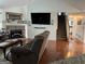 Comfortable living room with a brick fireplace, hardwood floors, and staircase at 521 Deadwood Trl, Locust Grove, GA 30248