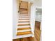 Basement stairs with wood treads and white risers at 661 Kennesaw Se Dr, Smyrna, GA 30080