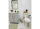 Well-lit bathroom featuring gray vanity, modern black hardware, and coordinated neutral and green accents at 661 Kennesaw Se Dr, Smyrna, GA 30080