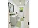 Cozy updated bathroom with granite countertops, soft green rugs, and modern fixtures at 661 Kennesaw Se Dr, Smyrna, GA 30080