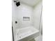 This bathroom features a shower/tub combination, black fixtures, and a tiled shower niche at 661 Kennesaw Se Dr, Smyrna, GA 30080