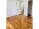 Bedroom showcasing hardwood floors and a glimpse into the ensuite bathroom at 661 Kennesaw Se Dr, Smyrna, GA 30080