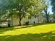 Two story house with large lawn and mature trees offers shade and curb appeal at 661 Kennesaw Se Dr, Smyrna, GA 30080