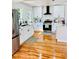 Bright kitchen featuring stainless steel appliances, white cabinets, and hardwood floors at 661 Kennesaw Se Dr, Smyrna, GA 30080