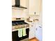 Well-equipped kitchen with a modern stove, white cabinets and beautiful countertops at 661 Kennesaw Se Dr, Smyrna, GA 30080