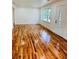 Sunlit living room boasts gleaming hardwood floors and large windows at 661 Kennesaw Se Dr, Smyrna, GA 30080