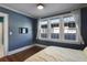 Inviting bedroom featuring hardwood floors, a television, and natural lighting through multiple windows at 824 Greenwood Ne Ave # 8, Atlanta, GA 30306