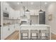 Well-lit kitchen boasts white cabinets, stainless steel appliances, a center island, and bar stool seating at 931 Willingham Dr # 10, Hapeville, GA 30354