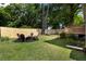 Spacious backyard featuring a fire pit, Adirondack chairs, privacy fence, and lush green lawn at 19 Wyman Se St, Atlanta, GA 30317
