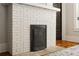 Elegant white-painted brick fireplace with a decorative metal grate, adding charm to the interior at 19 Wyman Se St, Atlanta, GA 30317