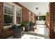 Inviting front porch featuring comfortable seating, brick columns, and stylish outdoor decor at 19 Wyman Se St, Atlanta, GA 30317