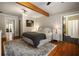 Serene main bedroom featuring hardwood floors, a ceiling beam, and an ensuite bathroom at 19 Wyman Se St, Atlanta, GA 30317