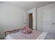 Cozy bedroom featuring neutral walls, plush bedding and a doorway to another room at 6345 Mountain Home Se Way, Mableton, GA 30126