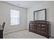 Cozy bedroom with a dresser, mirror, and window offering natural light at 6345 Mountain Home Se Way, Mableton, GA 30126