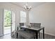 Dining area with modern table set and natural light from door to the backyard at 6345 Mountain Home Se Way, Mableton, GA 30126