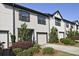 A row of identical townhomes, each boasting a one-car garage and manicured front yards at 6345 Mountain Home Se Way, Mableton, GA 30126