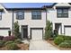 Charming townhome with a one-car garage and beautifully landscaped front yard at 6345 Mountain Home Se Way, Mableton, GA 30126
