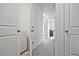 Hallway view featuring white doors, carpeted floor, and a glimpse into another room at 6345 Mountain Home Se Way, Mableton, GA 30126