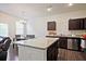 Open kitchen featuring a granite island, stainless steel appliances, and an adjacent dining area at 6345 Mountain Home Se Way, Mableton, GA 30126