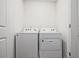 Laundry room featuring a white washer and dryer set, with a doorway view at 6345 Mountain Home Se Way, Mableton, GA 30126