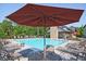 Community pool and lounge area featuring sunbeds, umbrellas, and a clubhouse at 6345 Mountain Home Se Way, Mableton, GA 30126