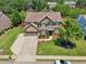 Beautiful suburban home featuring a lush lawn, mature trees, and a spacious driveway at 852 Van Briggle Path, Sugar Hill, GA 30518