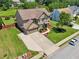 Spacious two-story home with a large driveway, lush green lawn, and mature trees at 852 Van Briggle Path, Sugar Hill, GA 30518