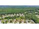 An aerial view showcasing the well-maintained homes nestled among mature trees at 852 Van Briggle Path, Sugar Hill, GA 30518