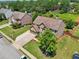 Suburban home with a well-maintained lawn, mature trees, and a two-car garage at 852 Van Briggle Path, Sugar Hill, GA 30518