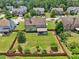 Aerial view of a home featuring a large fenced backyard with mature trees at 852 Van Briggle Path, Sugar Hill, GA 30518