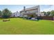 The backyard features a well-manicured lawn, covered patio, and mature trees, enhancing the outdoor experience at 852 Van Briggle Path, Sugar Hill, GA 30518